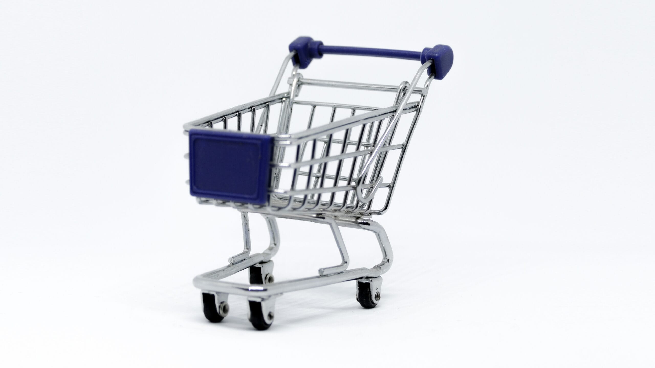 A miniature wire shopping cart with blue accents on a white background, representing the checkout process and cart abandonment in ecommerce.