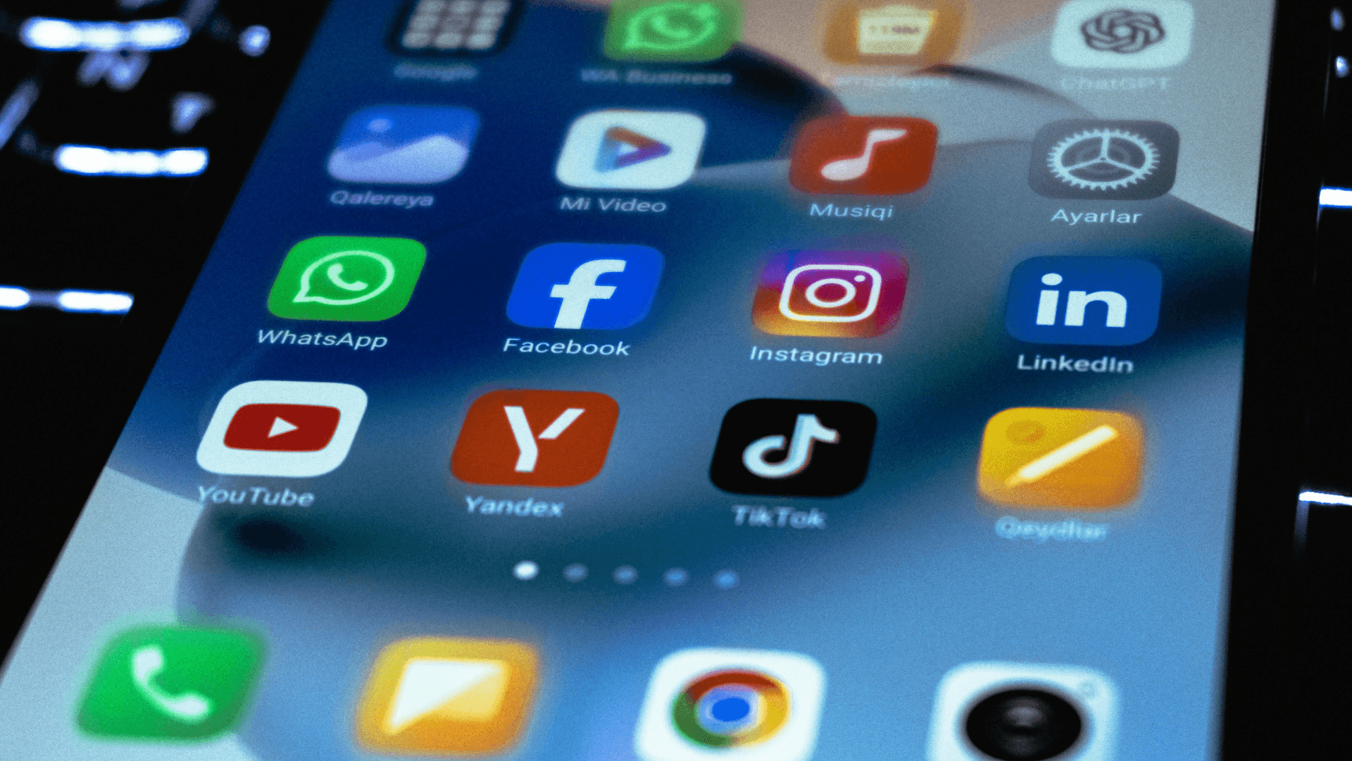 A close-up view of a smartphone screen displaying various social media and communication app icons, representing an integrated omnichannel approach for e-commerce brands.